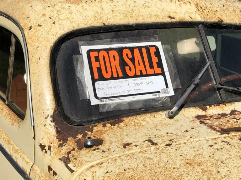 A "for sale" sign on an old vehicle