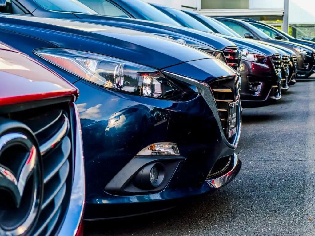 A row of Mazda 3s at a dealership