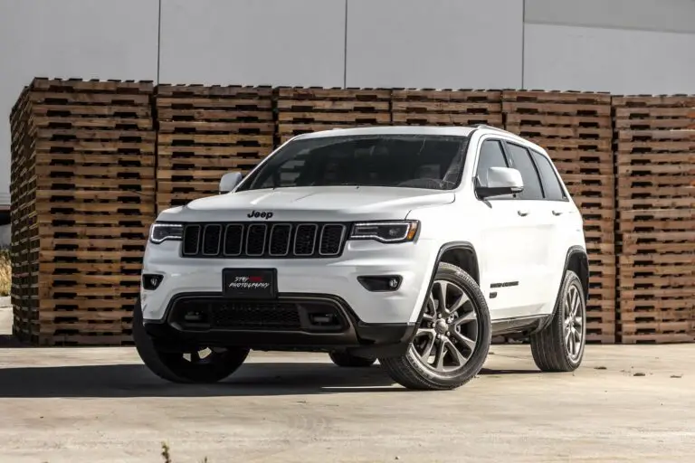 White SUV in front of a warehouse