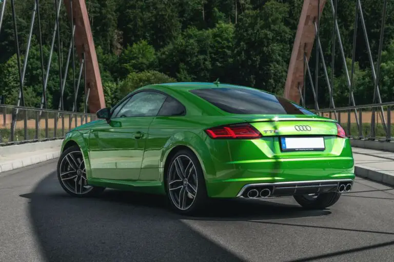 A green German sports car on a bridge