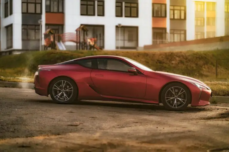 Red sports car on a dirt road